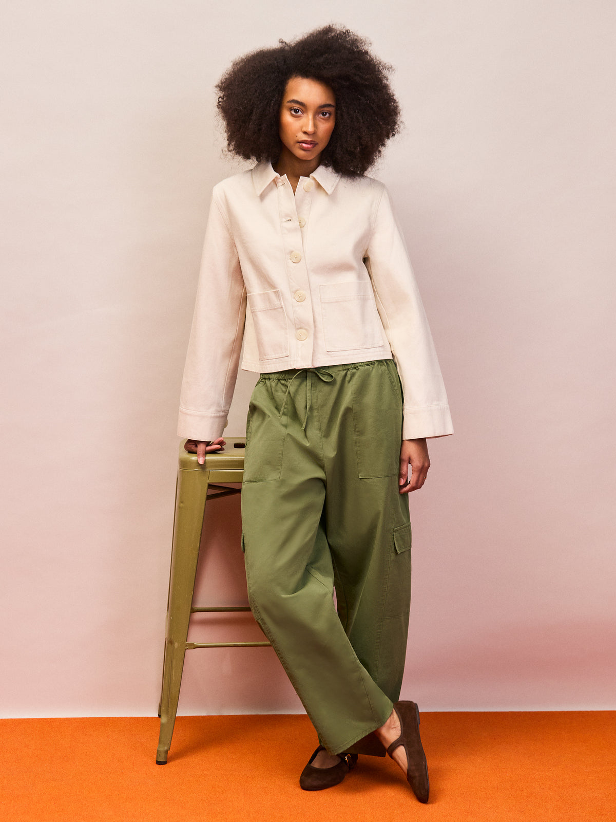 Ecru cotton twill cropped denim jacket styled with green trousers
