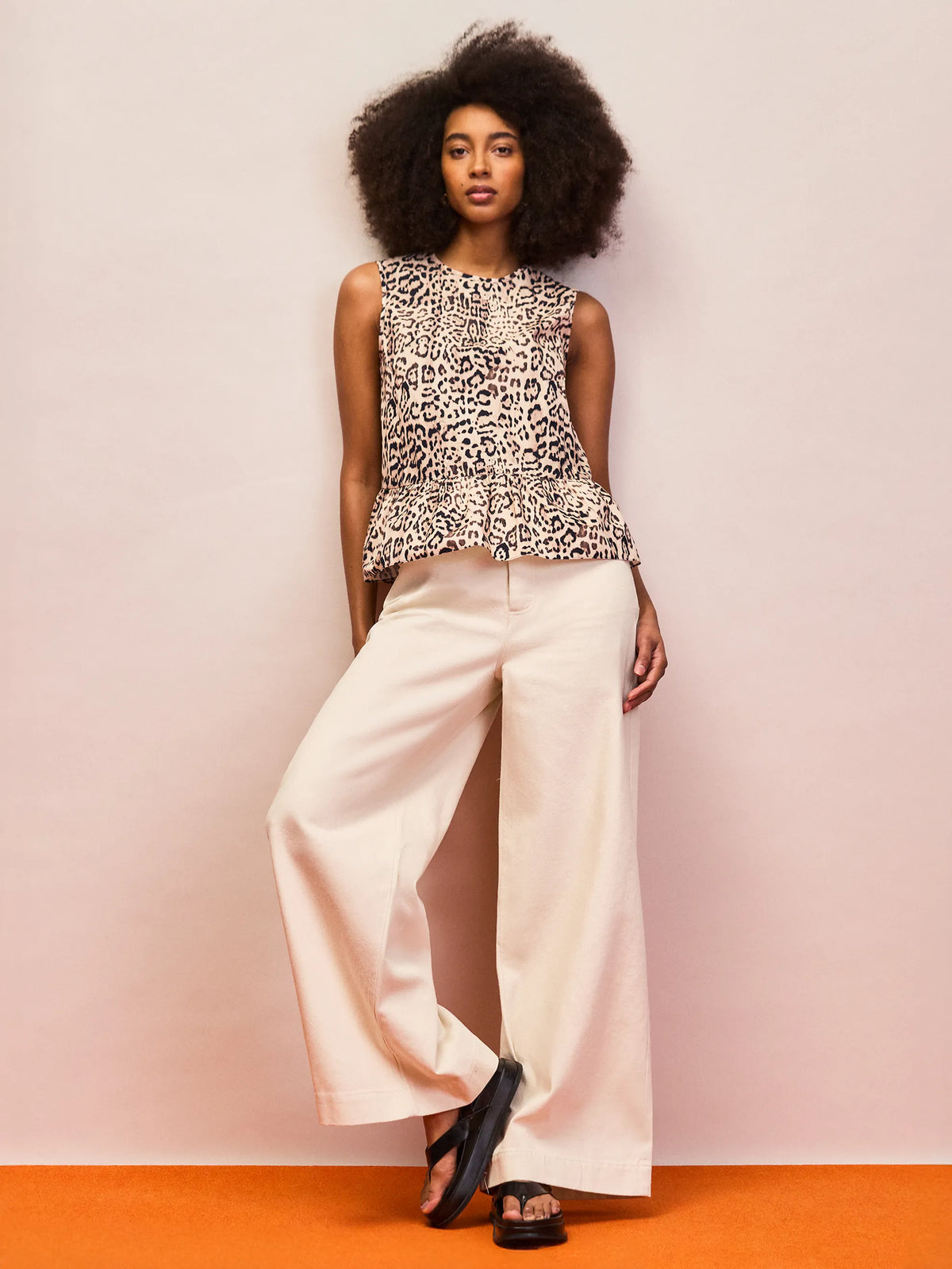 Animal print cotton peplum top with cinched waist seam and flowy silhouette