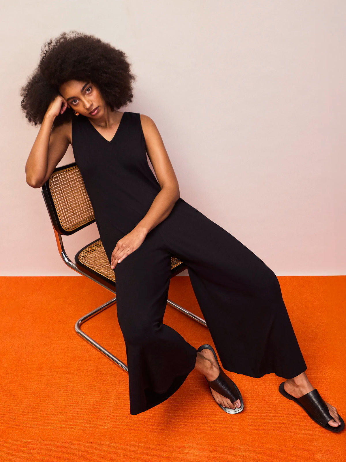 Women’s black V neck jersey jumpsuit featuring relaxed fit and flowing wide legs