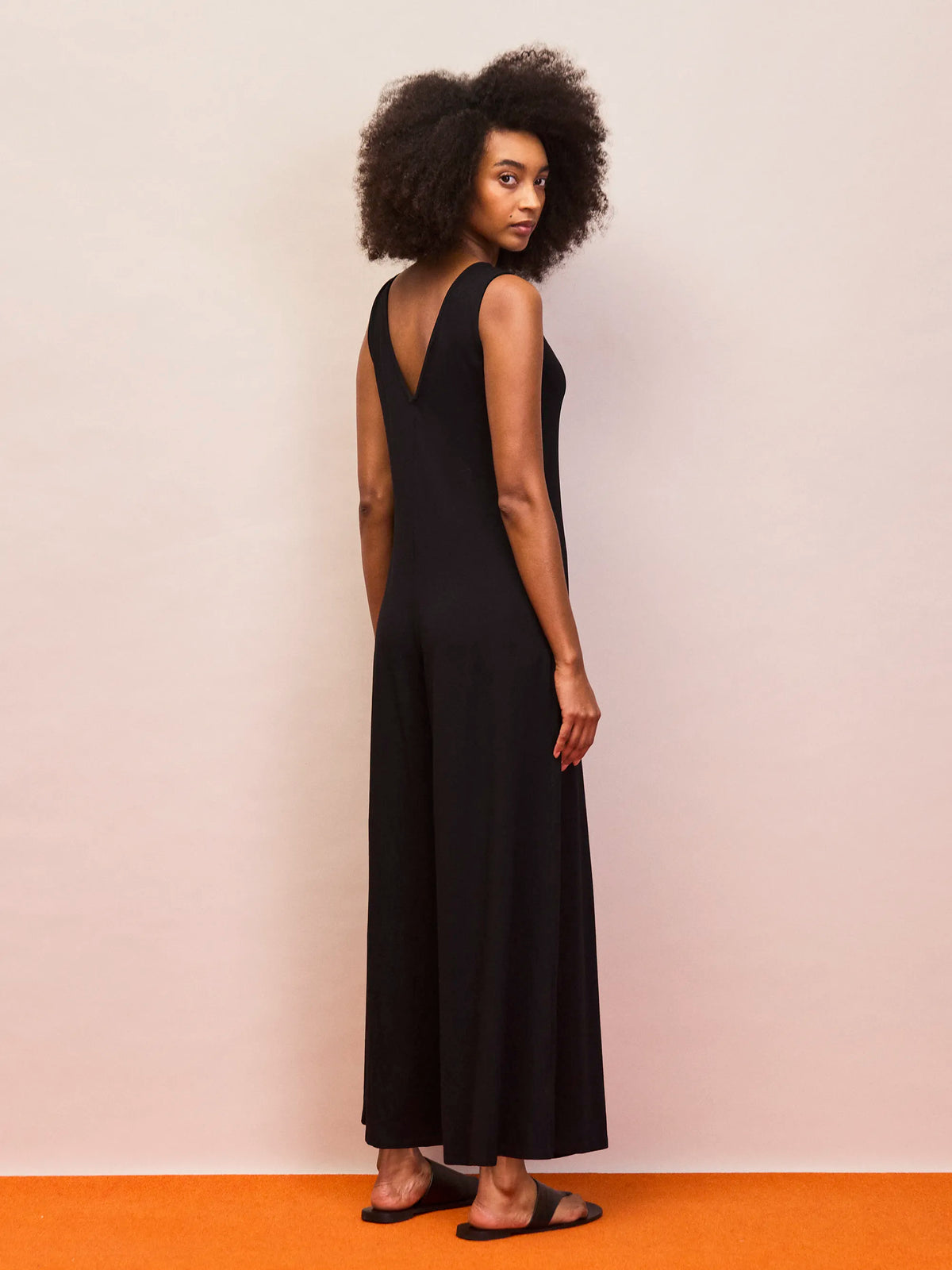 Minimalist black V neck wide leg jersey jumpsuit for effortless everyday wear