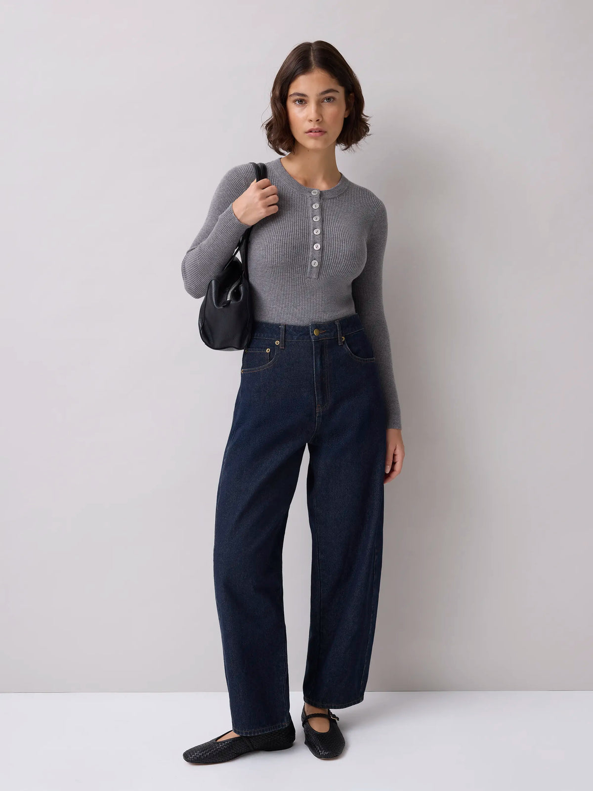 Grey rib knit Henley bodysuit with long sleeves and button front.