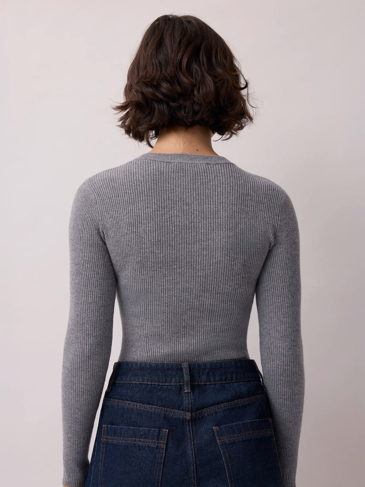 Grey rib knit Henley bodysuit with long sleeves and button front.