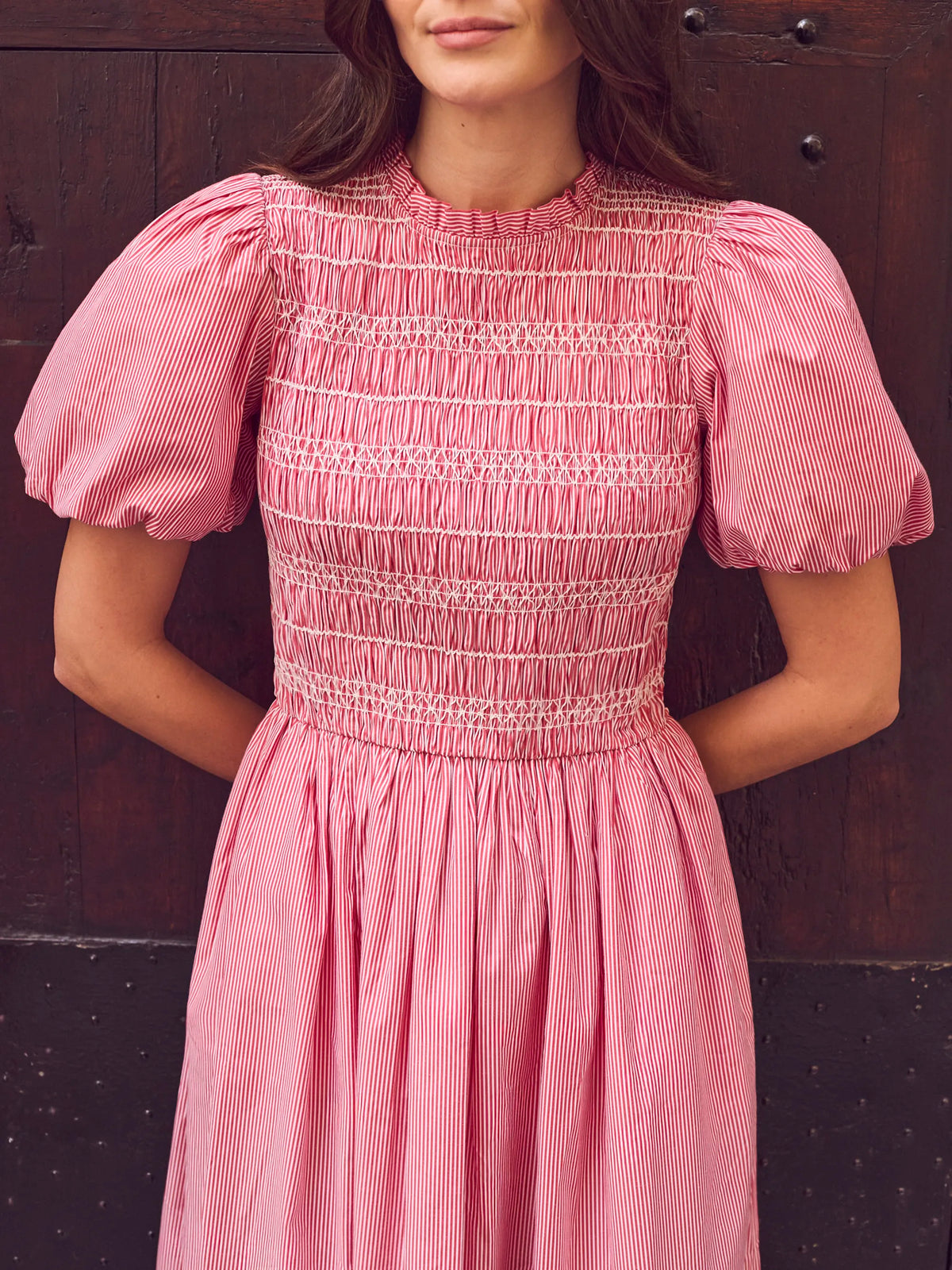 Red stripe midi dress with shirred bodice, puff sleeves, frill neckline and flowing skirt.