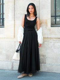 Black tulle midi skirt with shirred waist and sheer hem.