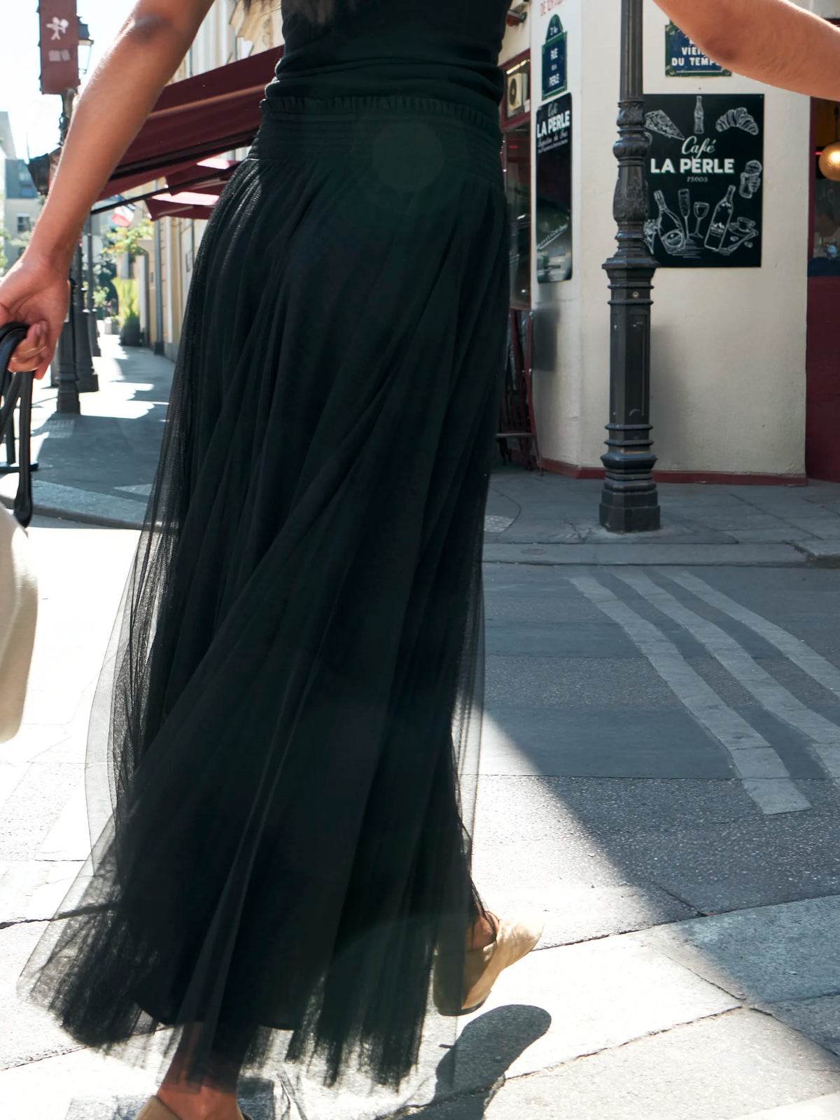 Black tulle midi skirt with shirred waist and sheer hem.