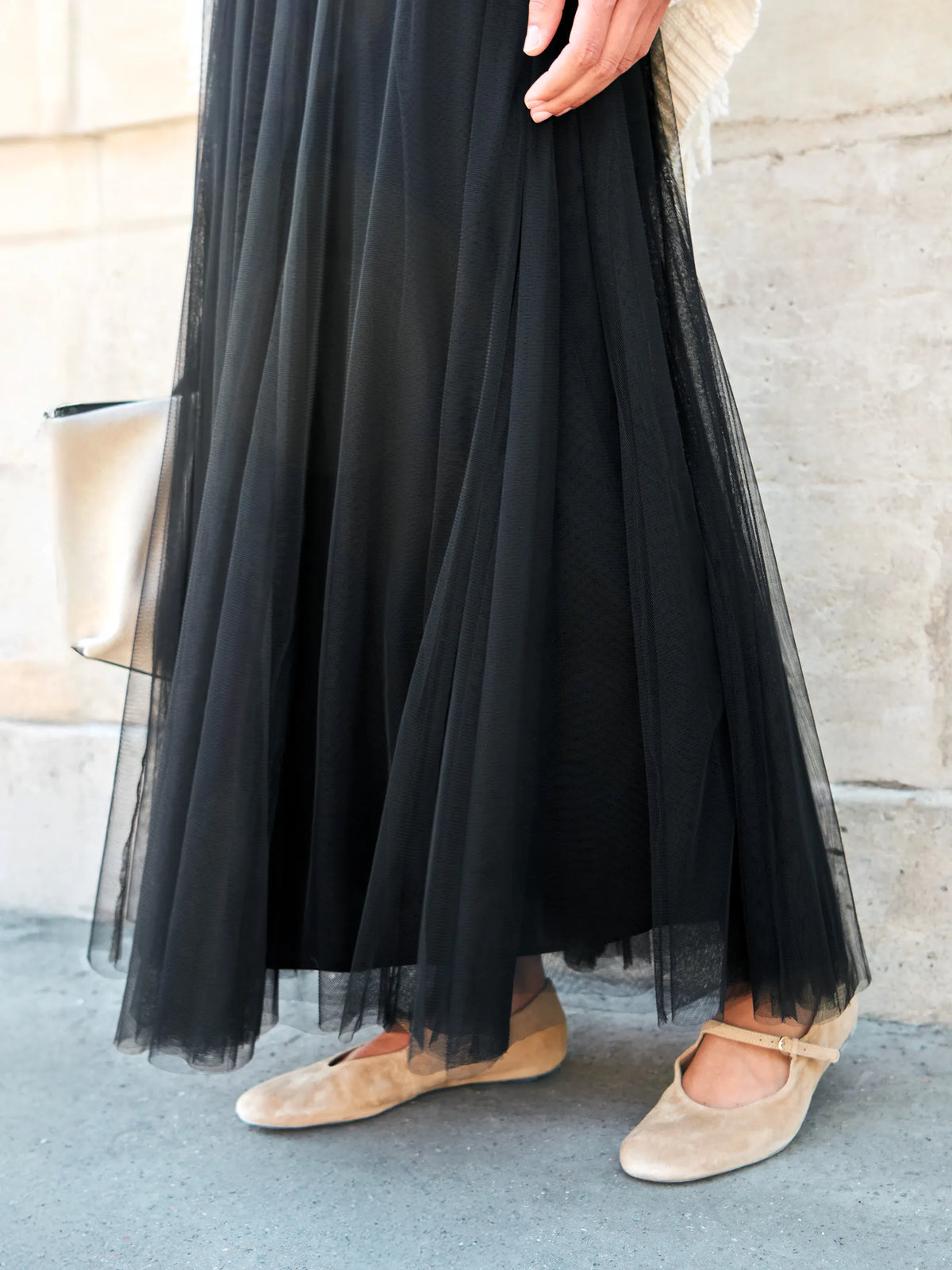 Black tulle midi skirt with shirred waist and sheer hem.